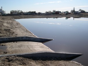 Concrete spillway into new impoundment prevents erosion